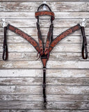 Floral and Sunflower Tooled Breast Collar and Headstall displayed on a wood background.