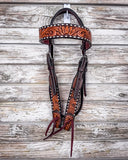 Floral and Sunflower Tooled Headstall displayed on a wood background.
