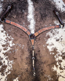 Floral and Sunflower Tooled Breast Collar displayed on cowhide.