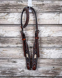 Turquoise Rawhide One Ear Headstall displayed on a wood background.