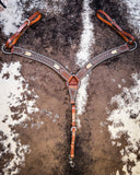 Turquoise Rawhide Breast Collar displayed on cowhide.
