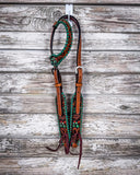 Painted Cactus One Ear Headstall displayed on a wood background.