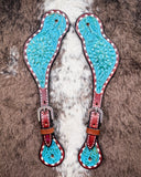 Turquoise Collection Ladies Spur Straps displayed on cowhide.