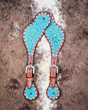 Turquoise Collection Ladies Spur Straps displayed on cowhide.