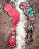Beaded Cactus Ladies Spur Straps displayed on cowhide.