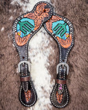 Beaded Cactus Ladies Spur Straps displayed on cowhide.