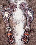 Turquoise Rawhide Ladies Spur Straps displayed on cowhide.