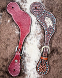 Turquoise Rawhide Ladies Spur Straps displayed on cowhide.