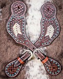 Turquoise Rawhide Ladies Spur Straps displayed on cowhide.