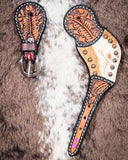 Cowhide and Brass Accent Ladies Spur Straps displayed on cowhide.