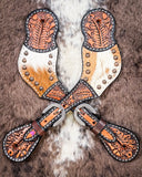 Cowhide and Brass Accent Ladies Spur Straps displayed on cowhide.