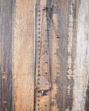 The Gilded Longhorn Fashion Necklace displayed on wood backdrop.