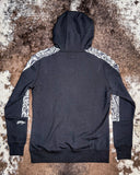 Canyon Ladies Hooey Hoodie being displayed on cowhide background.