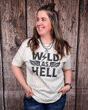 Wild As Hell Graphic Tee modeled and styled Infront of wood backdrop.