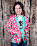 The Brynella Aztec Jacket on a model in front of a wood backdrop.