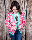 The Brynella Aztec Jacket on a model in front of a wood backdrop.