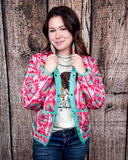 The Brynella Aztec Jacket on a model in front of a wood backdrop.