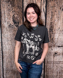 The Branded Pony Graphic Tee modeled and styled In front of a wood backdrop.