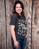 The Branded Pony Graphic Tee modeled and styled In front of a wood backdrop.
