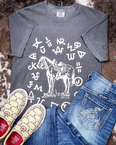 The Branded Pony Graphic Tee displayed and styled on hide background.