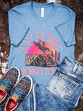 Let it Ride Rodeo Tour Graphic Tee displayed and styled on hide.