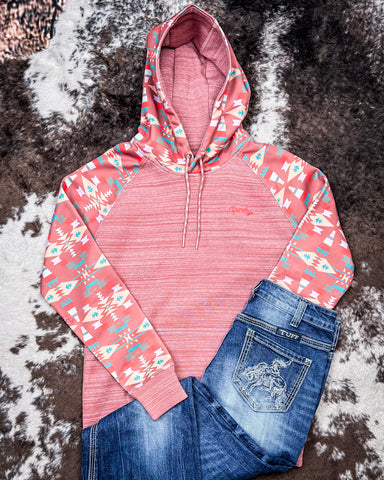 Punchy Ladies Hooey Hoodie in Mahogany with Aztec pattern displayed with jeans on cowhide.