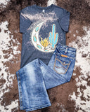 Desert Child Graphic Tee displayed and styled on hide background.