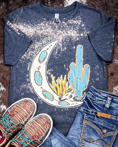 Desert Child Graphic Tee displayed and styled on hide background.