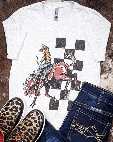 Bucking Horse Graphic Tee displayed and styled on hide background.