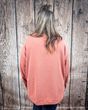 The Stillwater Tunic Top in color Rust being styled and modeled on women in front of wood backdrop.