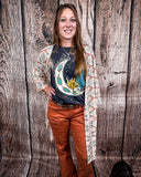Acoma Aztec Duster being styles and worn by a women in front if wood background.