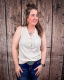 The Lanie Tank in Oatmeal being styled with jeans and modeled on a women in front of wood backdrop.