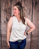 The Lanie Tank in Oatmeal being styled with jeans and modeled on a women in front of wood backdrop.