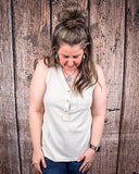 The Lanie Tank in Oatmeal being styled with jeans and modeled on a women in front of wood backdrop.