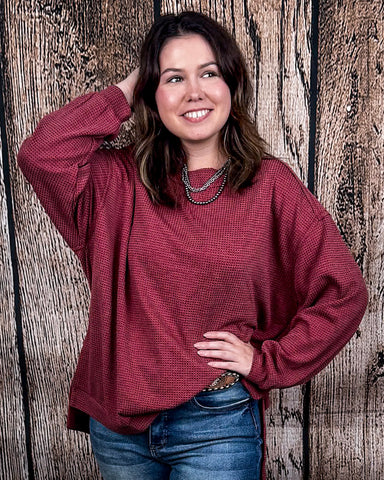 The Stillwater Tunic Top being styled  and modeled by women in front of wooden backdrop.