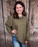 The Stillwater Tunic Top in Olive being styled and modeled on women in front of wooden backdrop.