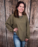 The Stillwater Tunic Top in Olive being styled and modeled on women in front of wooden backdrop.
