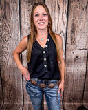 The Lanie Tank in black being styled and modeled by a women in front of wood background.