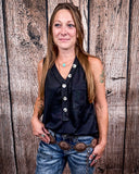 The Lanie Tank in black being styled and modeled by a women in front of wood background.