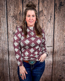 High Plains Aztec Top being styled with jeans and modeled by a women in front of wood background.