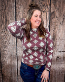 High Plains Aztec Top being styled with jeans and modeled by a women in front of wood background.