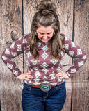 High Plains Aztec Top being styled with jeans and modeled by a women in front of wood background.