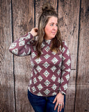 High Plains Aztec Top being styled with jeans and modeled by a women in front of wood background.
