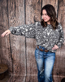 Tooled in Love Ribbed Sweater Top being modeled and styled on a women in front of wood backdrop.
