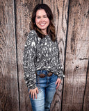Tooled in Love Ribbed Sweater Top being modeled and styled on a women in front of wood backdrop.