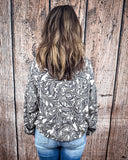 Tooled in Love Ribbed Sweater Top being modeled and styled on a women in front of wood backdrop.
