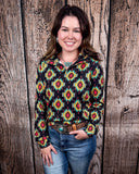 The Palmer Pullover being styled with jeans and worn by a women in front of wood background.