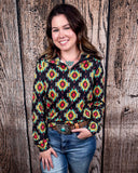 The Palmer Pullover being styled with jeans and worn by a women in front of wood background.