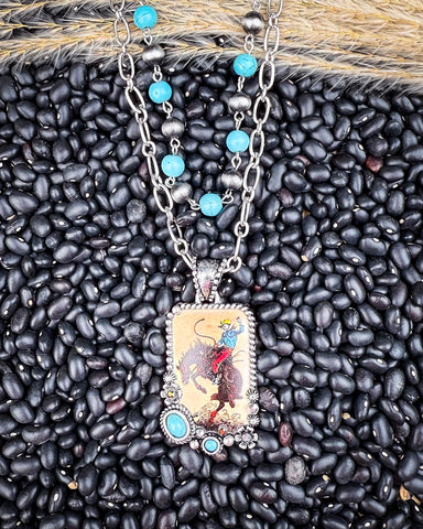 Wild West Layered Fashion Necklace displayed on black pebbles and wheat background.