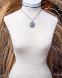 Hobbs Pendant Fashion Necklace displayed on mannequin in front of wheat background.